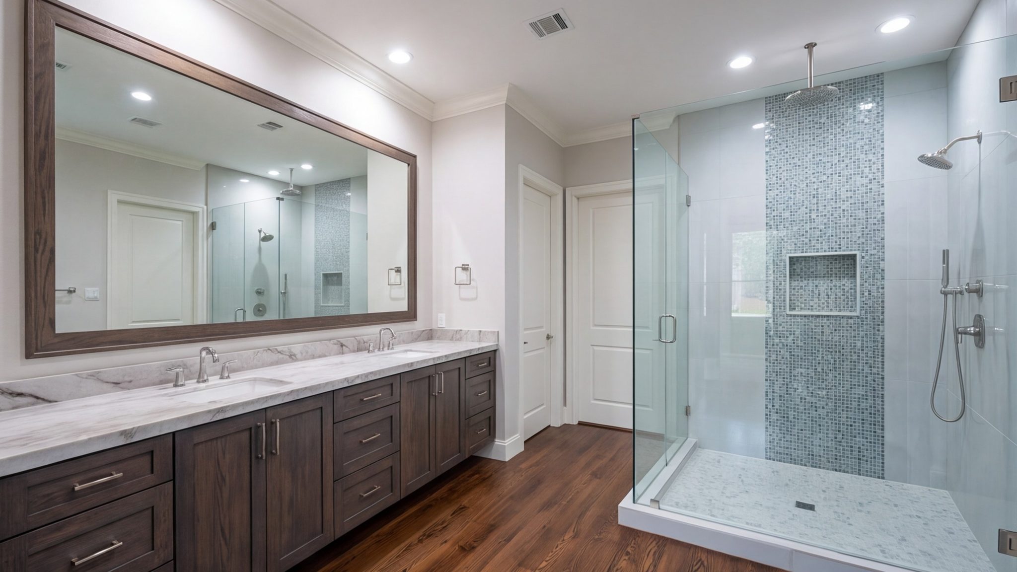 Double vanity bathroom with a glass shower and wood floor